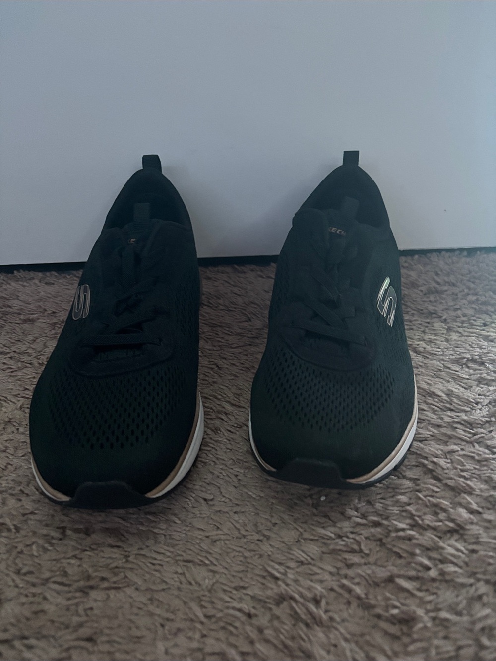 Skechers Women’s Black Slip-On Athletic Shoes with Silver Logo Detail
